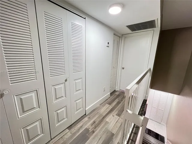 a bedroom with a balcony a bed and a large window