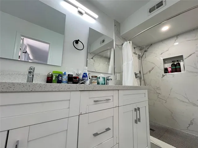 a view of walk in closet with clothes