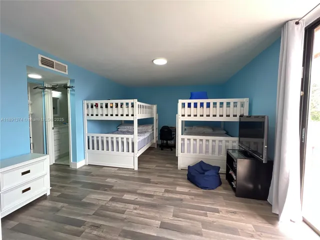 a patio with table and chairs and potted plants