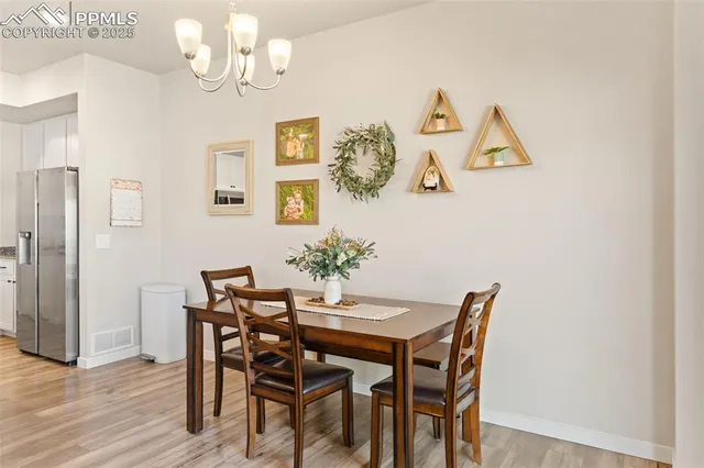 a view of a dining room with furniture and chandelier