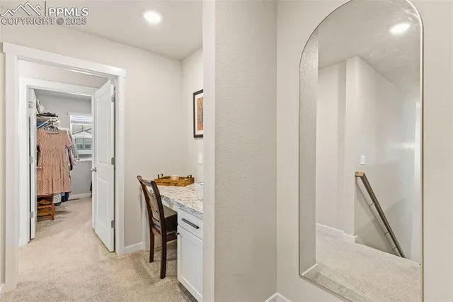a view of a hallway with furniture and front door