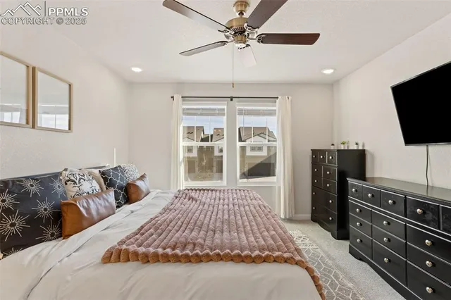a bedroom with a large bed and a flat screen tv