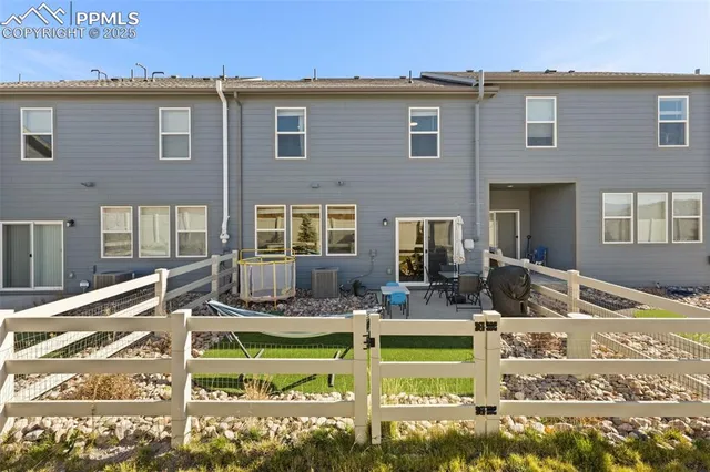 a front view of a house with swimming pool and glass windows
