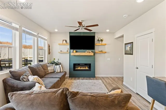 a living room with furniture a fireplace and a flat screen tv