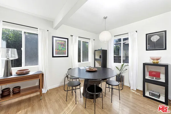 a view of a dining room with furniture window and wooden floor