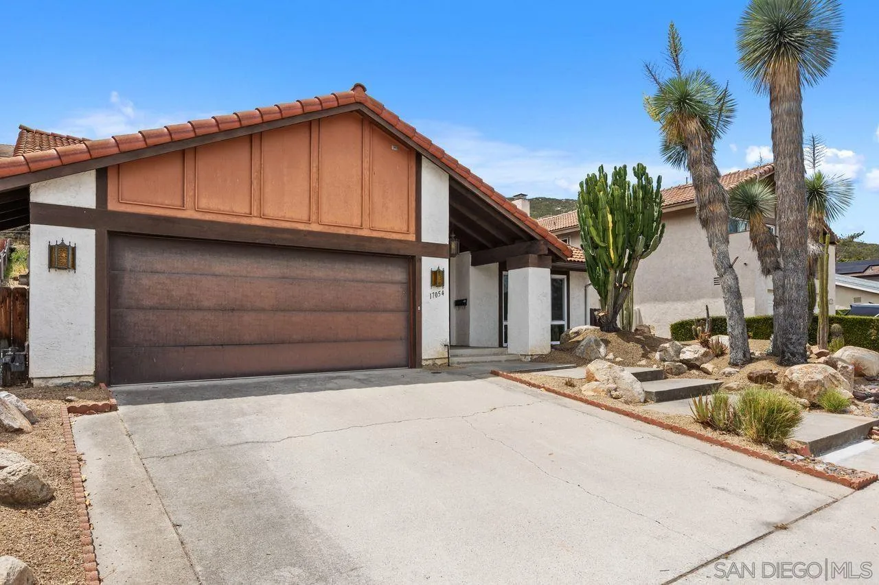 17054 Matinal Road San Diego, CA 92127 - Photo 1 of 50 a yellow house with trees in front of it