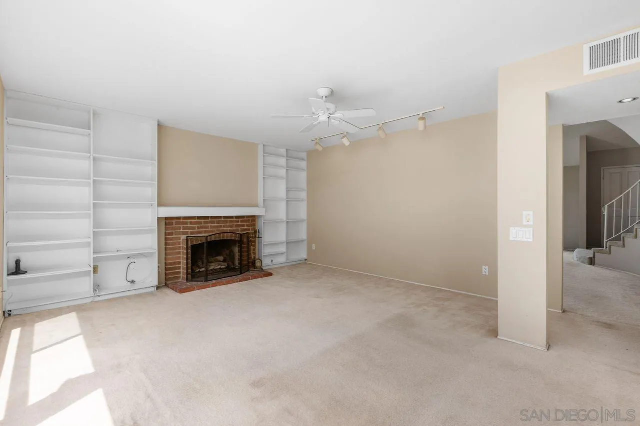 17054 Matinal Road San Diego, CA 92127 - Photo 11 of 50 a view of an empty room with a fireplace