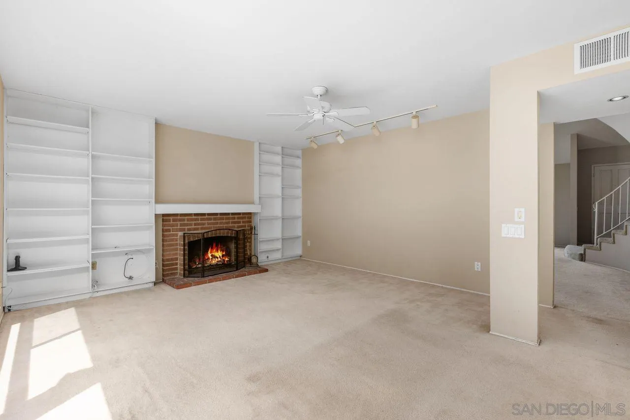 17054 Matinal Road San Diego, CA 92127 - Photo 12 of 50 a view of an empty room with a fireplace
