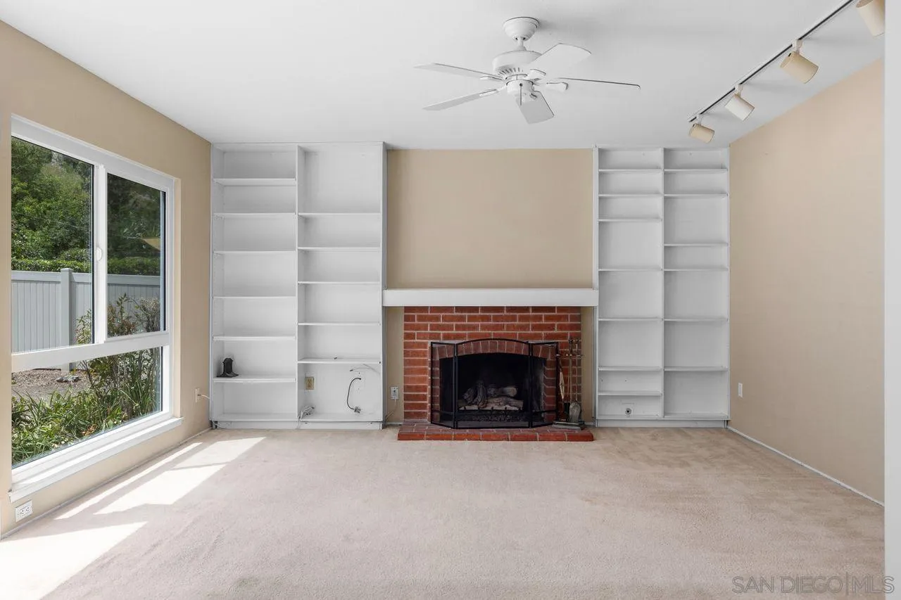 17054 Matinal Road San Diego, CA 92127 - Photo 13 of 50 a living room with furniture and a fireplace