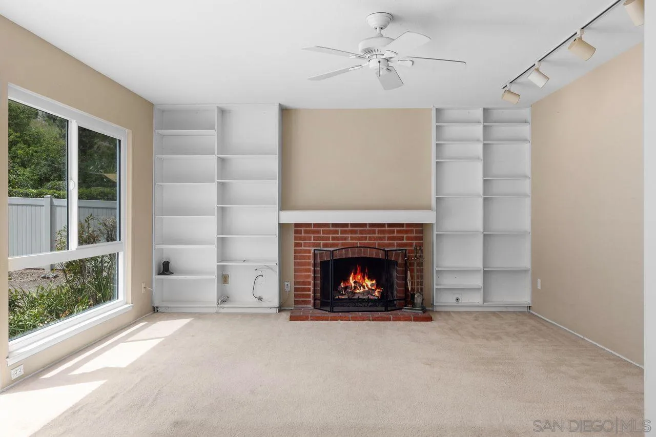 17054 Matinal Road San Diego, CA 92127 - Photo 14 of 50 a living room with furniture and a fireplace