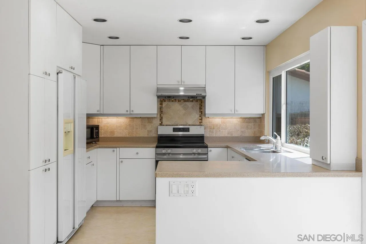 17054 Matinal Road San Diego, CA 92127 - Photo 15 of 50 a kitchen with stainless steel appliances granite countertop a stove and a refrigerator