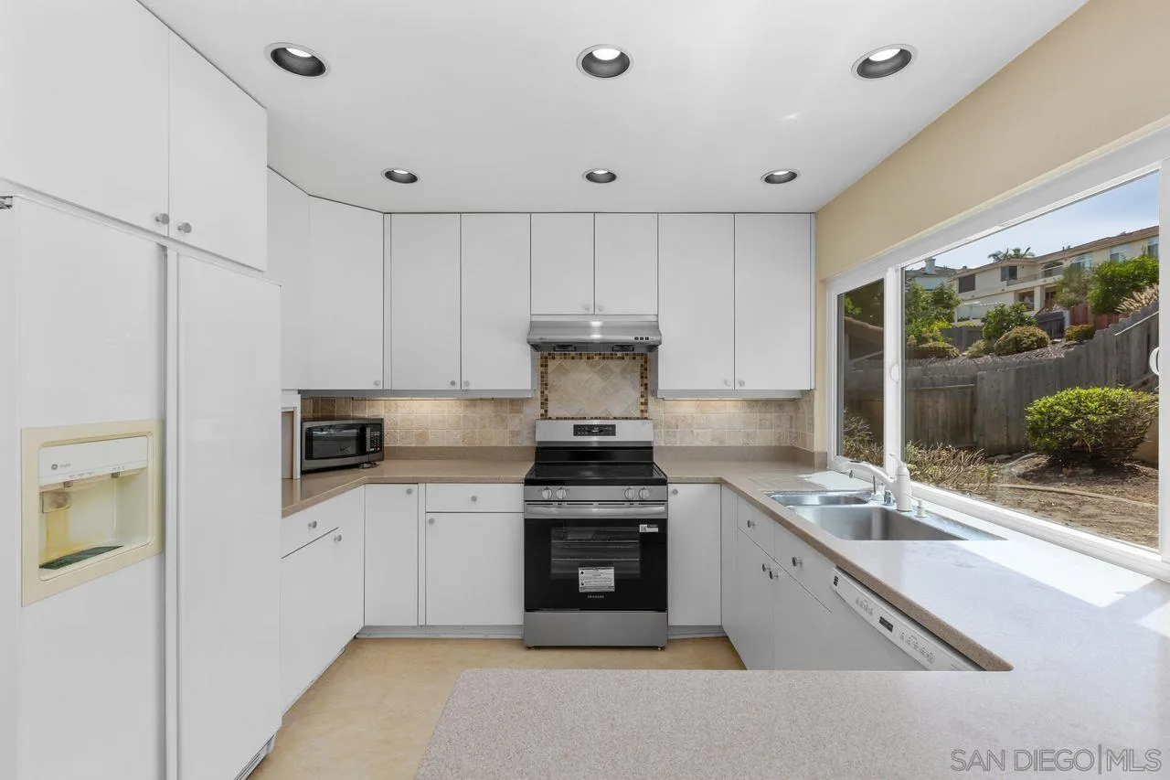 17054 Matinal Road San Diego, CA 92127 - Photo 16 of 50 a kitchen with stainless steel appliances granite countertop a stove and a sink