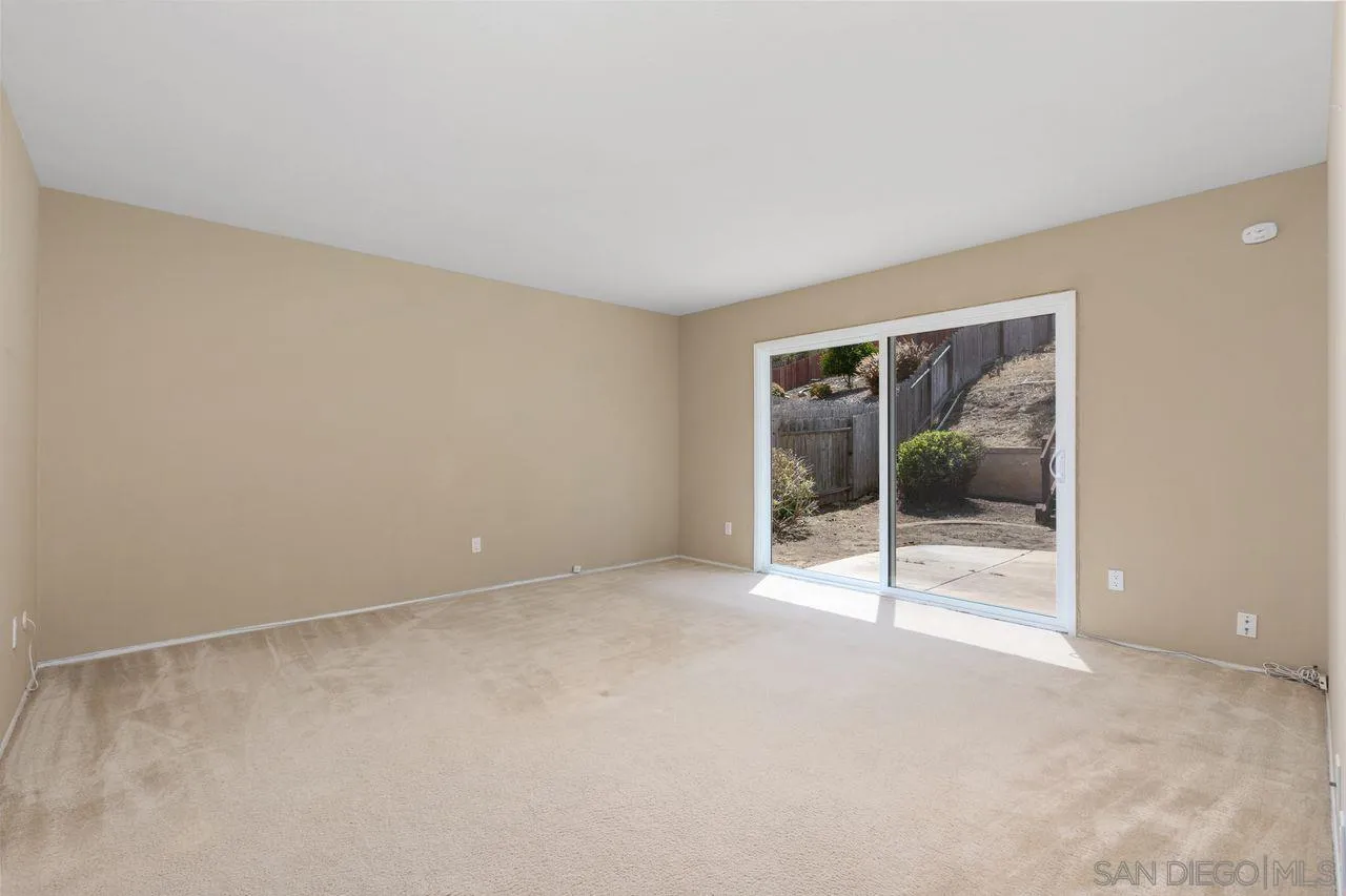 17054 Matinal Road San Diego, CA 92127 - Photo 22 of 50 an empty room with glass door and glass door