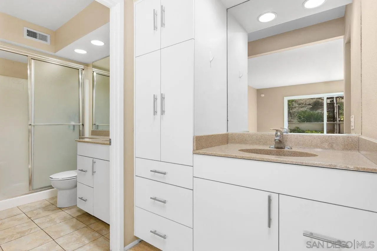 17054 Matinal Road San Diego, CA 92127 - Photo 26 of 50 a bathroom with a granite countertop sink toilet and shower