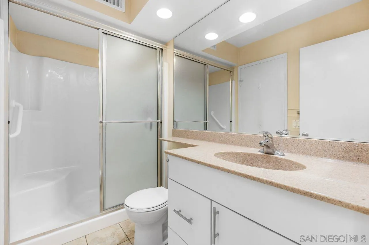 17054 Matinal Road San Diego, CA 92127 - Photo 27 of 50 a bathroom with a granite countertop sink toilet and shower