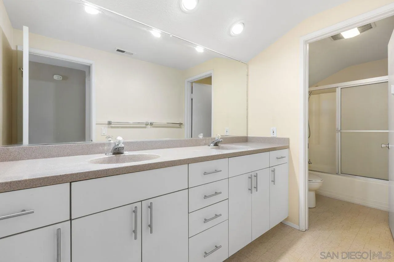 17054 Matinal Road San Diego, CA 92127 - Photo 32 of 50 a bathroom with double sink and a mirror