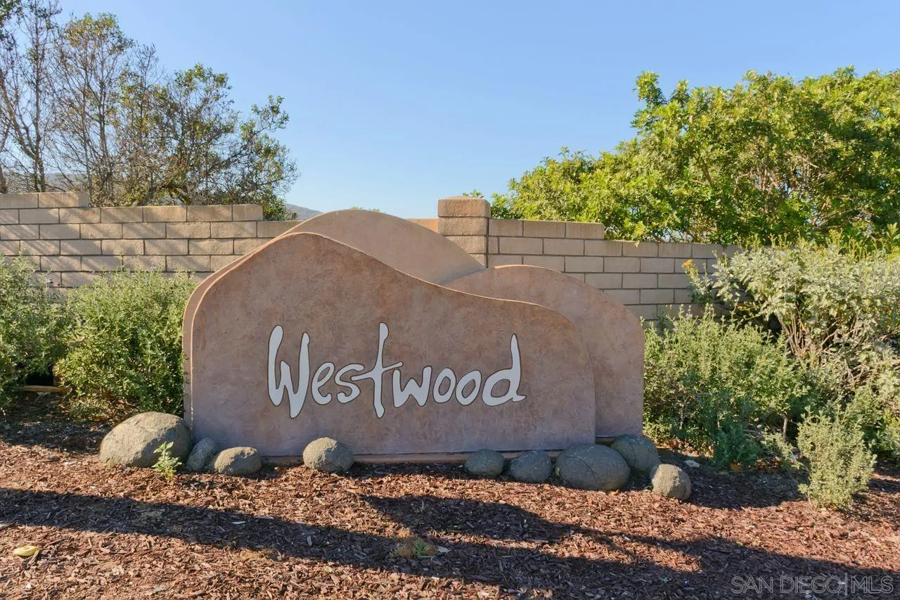 17054 Matinal Road San Diego, CA 92127 - Photo 40 of 50 a sign that is sitting on a brick wall