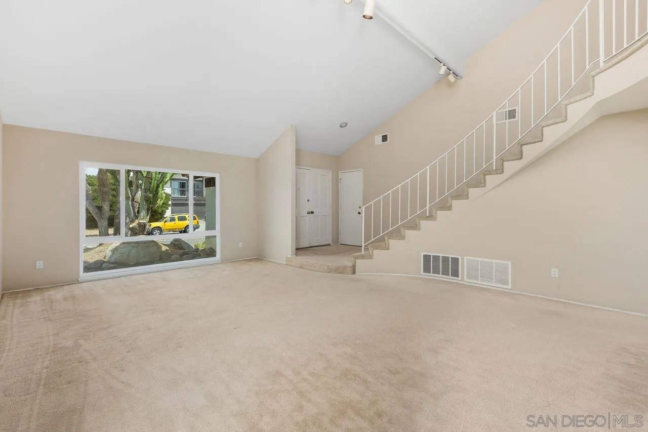 17054 Matinal Road San Diego, CA 92127 - Photo 6 of 50 a view of an empty room with stairs and windows