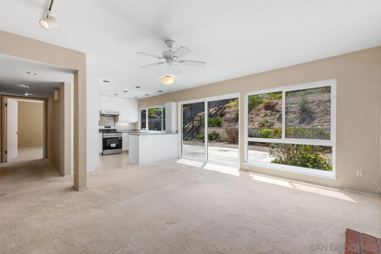 17054 Matinal Road San Diego, CA 92127 - Photo 10 of 50 a view of a kitchen with furniture and a large window