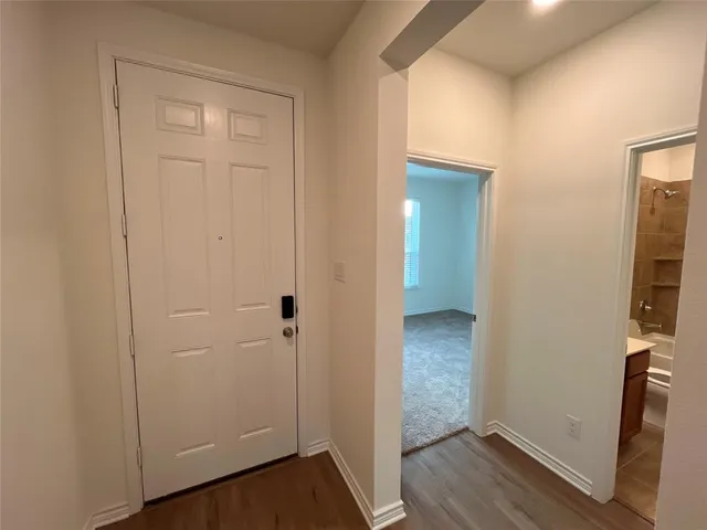 an empty room with wooden floor