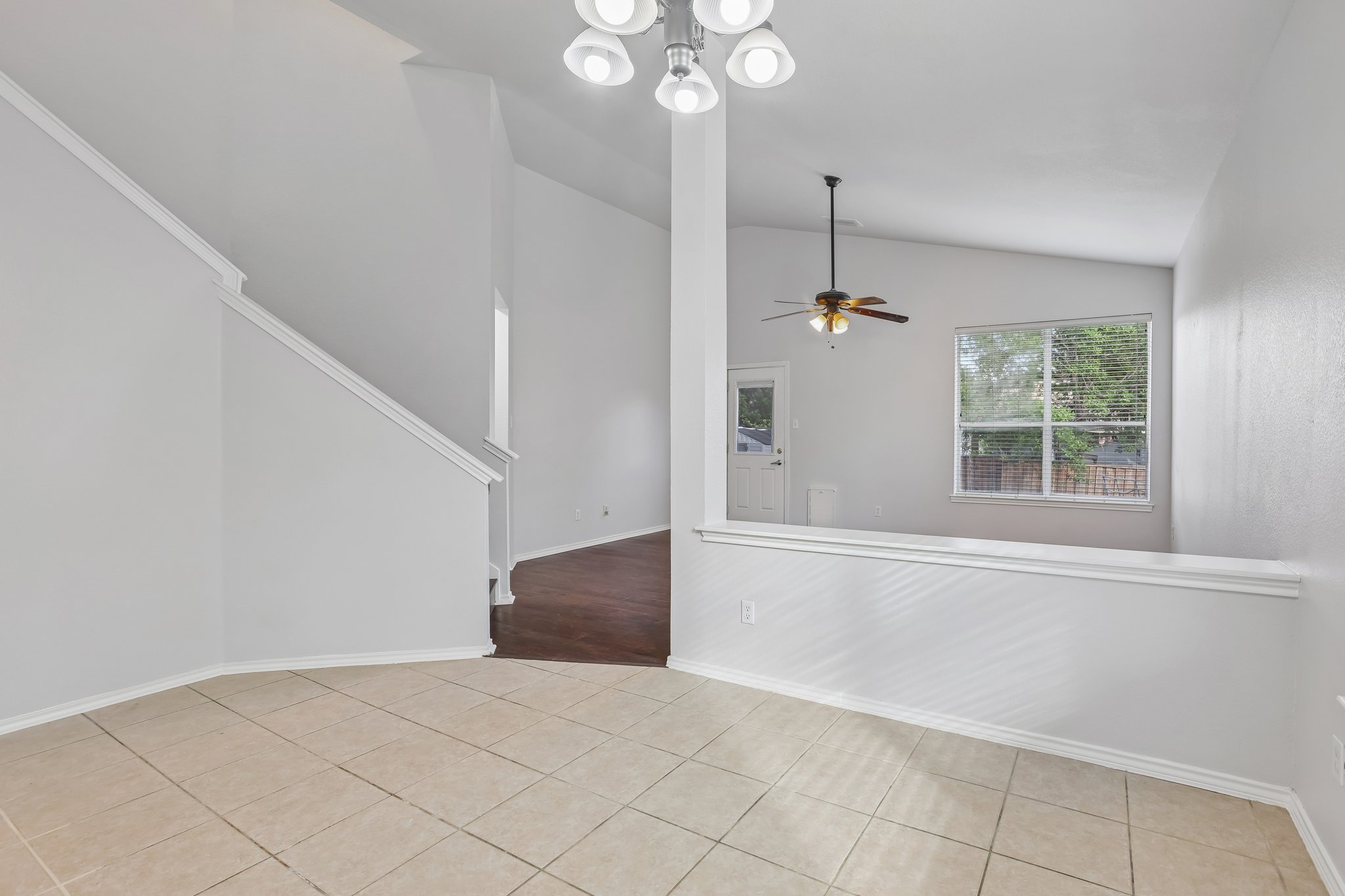 1721 Long Rifle Drive Austin, TX 78754 - Photo 8 of 38 The high ceilings and bright atmosphere create an inviting living area with varied flooring and natural light.