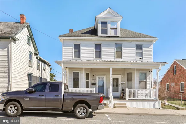 a front view of a house with a parking space