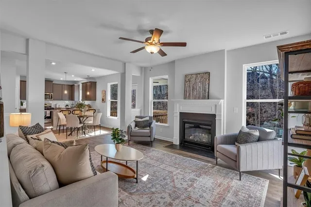 a living room with furniture a fireplace and a chandelier