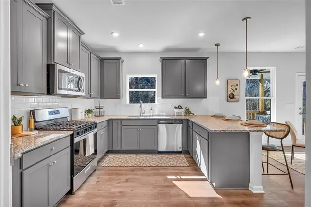 a kitchen with a sink stove top oven and cabinets