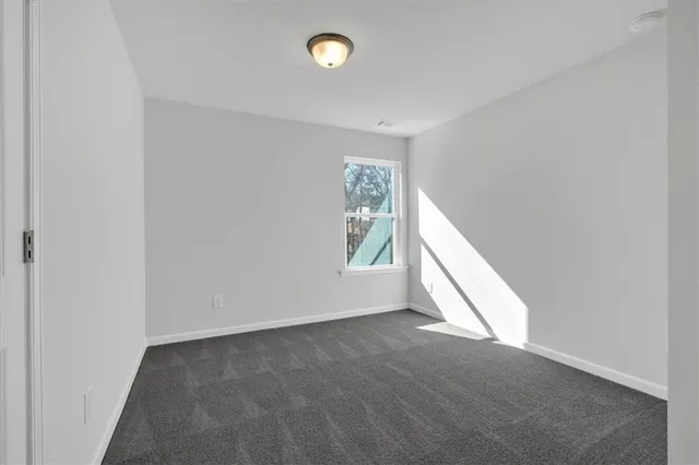 a view of an empty room with windows