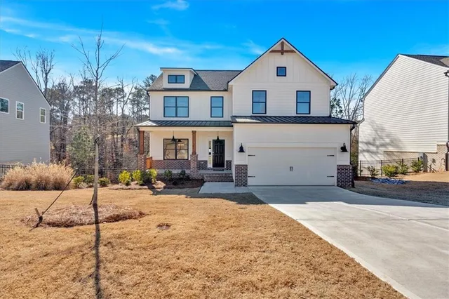 a view of a white house with a yard