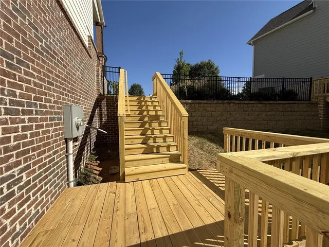 a view of balcony with wooden floor and fence