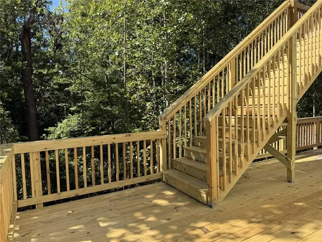 a view of balcony with wooden floor and fence