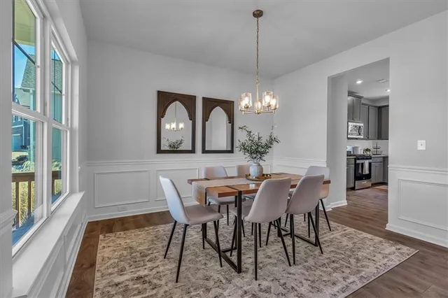 a view of a dining room with furniture window and wooden floor