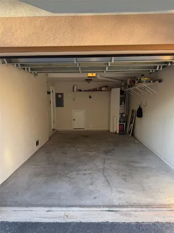 a view of a house with a small yard and wooden floor and fence