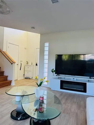 a living room with furniture and a flat screen tv