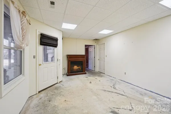 a view of empty room with a fireplace