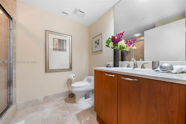 a bathroom with a toilet sink and mirror