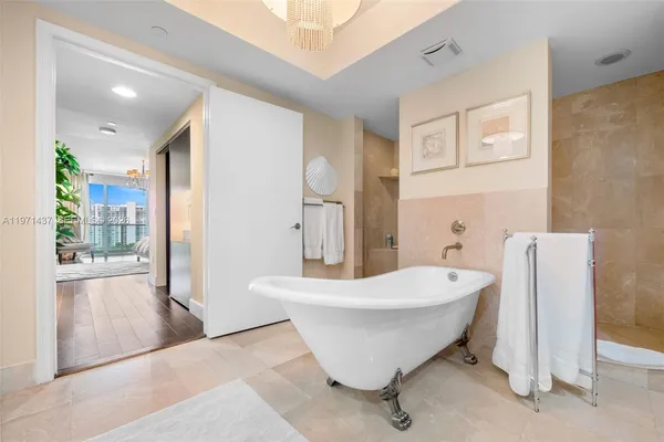 a spacious bathroom with a bathtub and shower