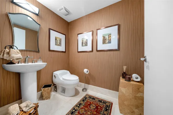 a bathroom with a sink toilet and a mirror
