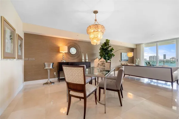 a view of a dining room with furniture and chandelier