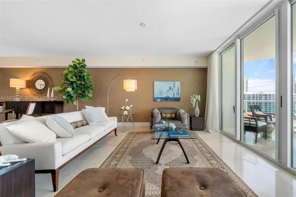 a living room with furniture a lamp and a potted plant