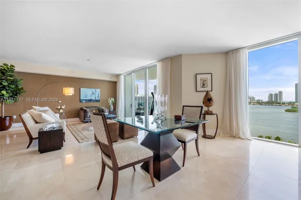 a living room with furniture and a floor to ceiling window