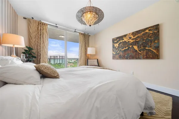 a bedroom with a bed and a painting on the wall