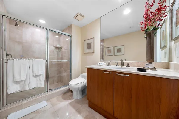 a bathroom with a granite countertop sink toilet and shower