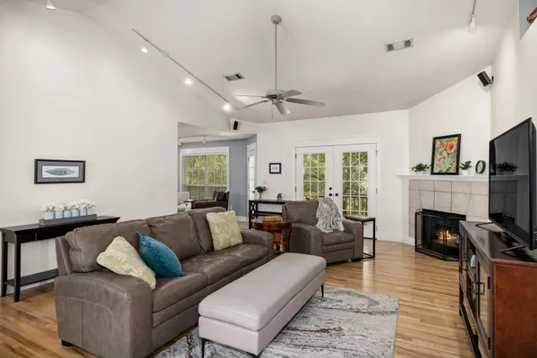 a living room with furniture a flat screen tv and a fireplace