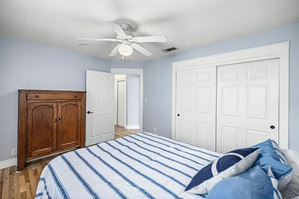 a view of an empty room with a window and a dresser