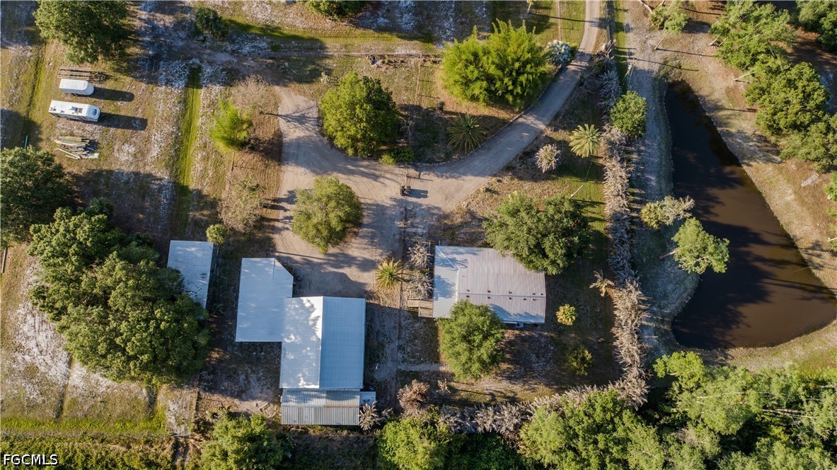 3880 Packinghouse Road Alva, FL 33920 - Photo 5 of 29 an aerial view of a house with a yard and garden