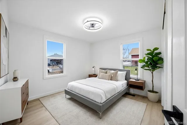 a bedroom with a bed and a potted plant