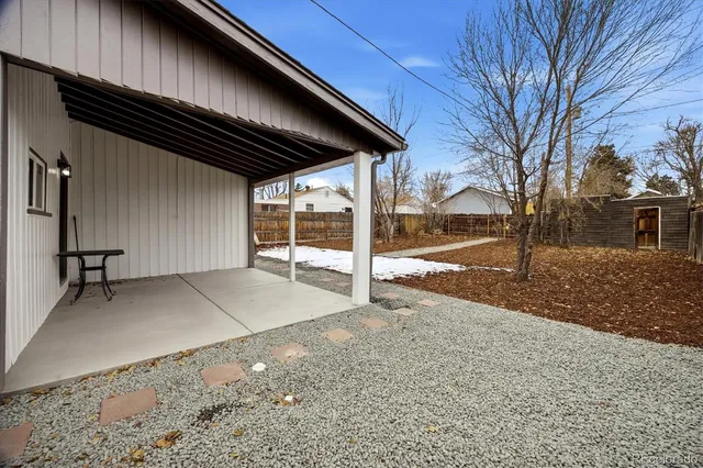 a view of a backyard with wooden fence