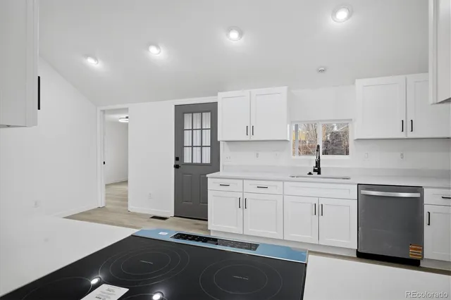 a kitchen with a sink stove and cabinets